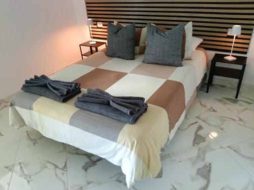 a bedroom with a large bed with towels on it at Casa Cristal in Arona