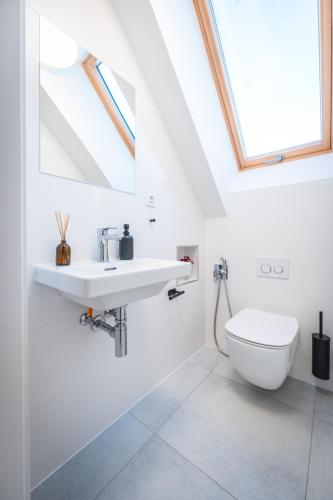 a bathroom with a sink and a toilet at Jiná báseň in Pustá Rybná