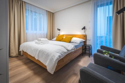 a bedroom with a large bed with yellow pillows at Jiná báseň in Pustá Rybná