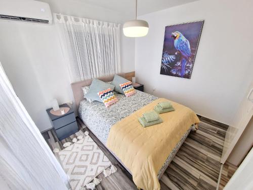 a bedroom with a bed and a painting on the wall at Triumph 1 - A in Paralimni