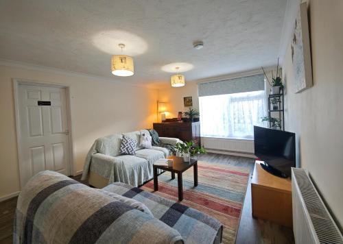 a living room with two couches and a television at Spacious 3 Bedroom Home Ample Parking Near Shops in Bridgemary