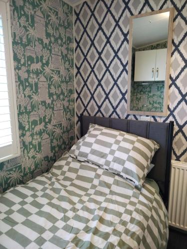 a bedroom with a bed and a mirror in it at Dog Friendly Holiday Home in Northampton