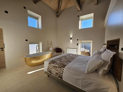 a bedroom with a tub and a bed and a sink at CASA ioio in Jaunay-Clan