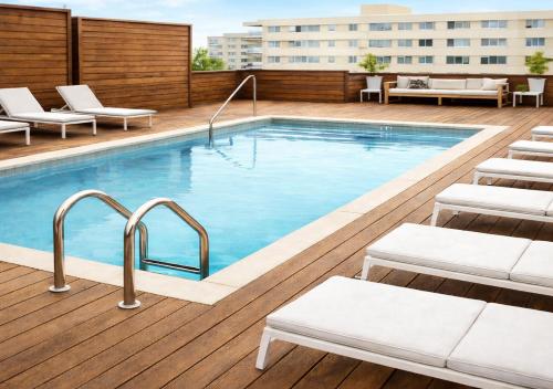 a swimming pool on top of a building at Drop Your Bags In Your 2 Bdrm, 2 Full Bath Condo In French Quarters Prime Location in New Orleans