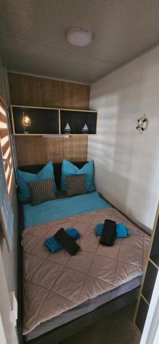 a large bed with blue pillows on top of it at Doris in Pakoštane