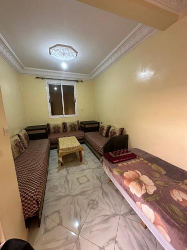 a living room with couches and a table at Apparemment tafoukt in Tafraout
