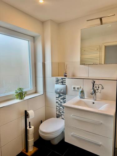 a bathroom with a toilet and a sink at Im Point von Kiel City in Kiel