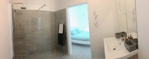 a bathroom with a shower and a sink and a tub at DuMar Beachouse in Salema