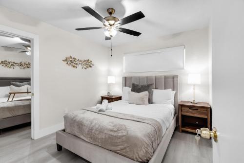 a bedroom with a bed and a ceiling fan at Hollywood 4BR Home with Private Heated Pool in Hollywood