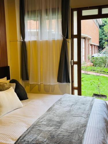 a bedroom with a bed and a window with at Utopía Hotel Boutique in Mexico City