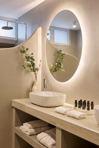 a bathroom with a sink and a mirror at Alaia Boutique houses in Batsi