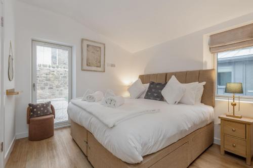 a bedroom with a large bed and a window at Rusheen Cottage in St. Andrews
