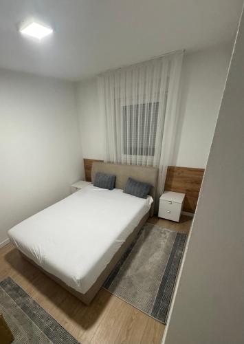 a bedroom with a white bed and a window at Stan na dan Jelah in Jelah