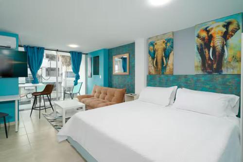 a bedroom with a large bed and a living room at Leb'Den Executive Suites in Cali