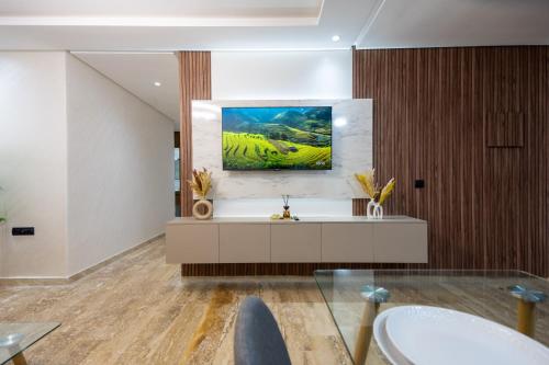 a bathroom with a sink and a painting on the wall at Magnificent apartment 10 in Casablanca