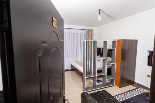 a room with a bed and a crib in a room at MIG Studios in Nakuru