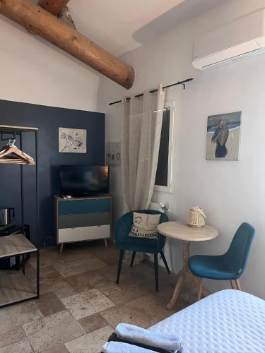 a room with a table and chairs and a bed at Maison d'hôtes Bastide St Victor à 2,5 kilomètres de Lourmarin in Puyvert