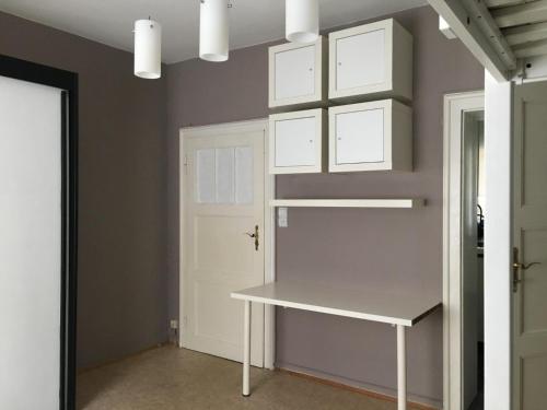 a room with a white table and a white door at Stadtmitte Ferienwohnung in Darmstadt