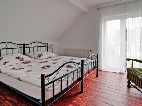 a bedroom with a large bed with flowers on it at Ferienhaus Vogelsberg in Mechernich