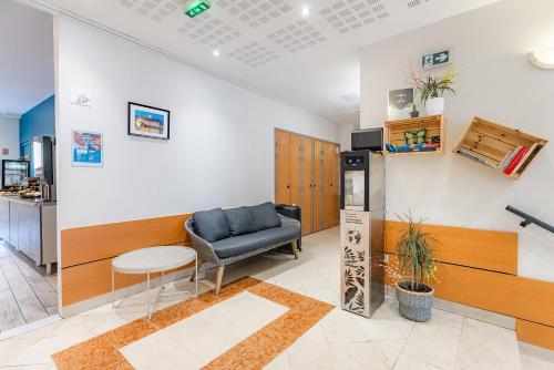 a waiting room with a chair and a table at Appart'City Classic Lyon Part Dieu Garibaldi in Lyon