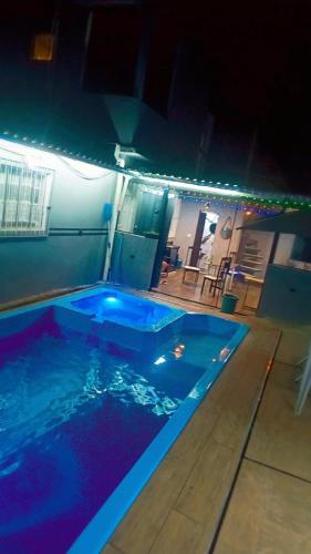 a large swimming pool in a house at night at Espaço Bezerra in Itaquaquecetuba