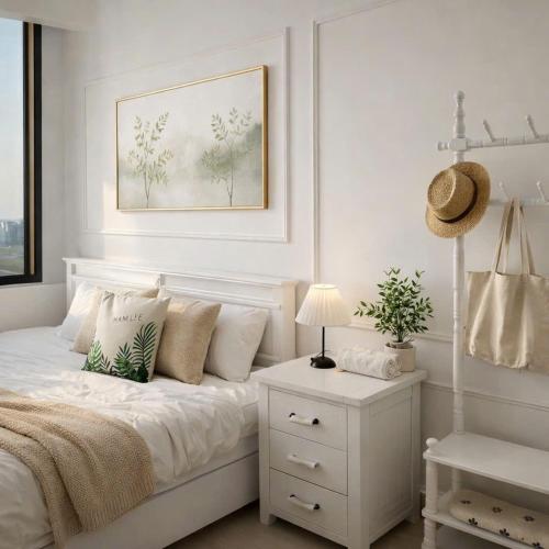 a bedroom with a white bed with a white nightstand at Hue Oi Homestay - Spacious 3-Bedroom Apartment with Balcony & Pool in Hue