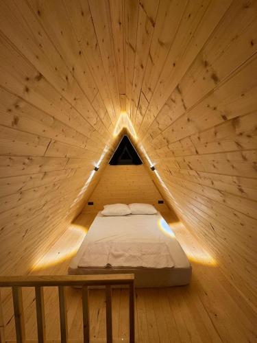 a bedroom with a bed in a wooden room at Evergreen Lodge in Çakırlar