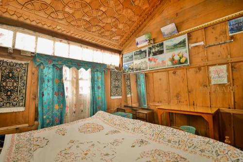 a bedroom with a bed and wooden walls at Dolphin houseboat in Srinagar