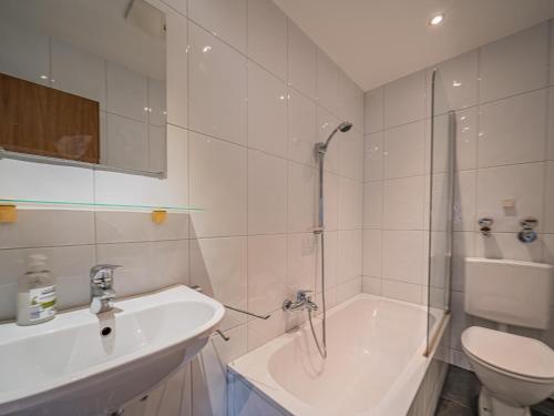 a bathroom with a sink and a toilet and a shower at Großvenediger in Mittersill