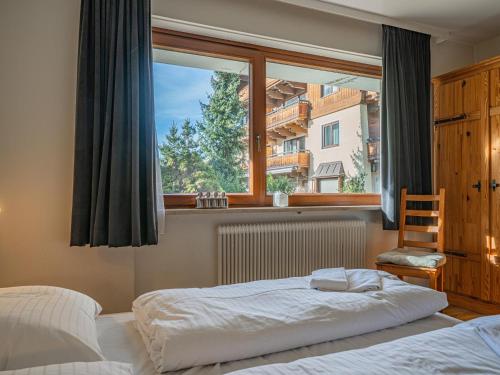 a bedroom with a bed and a large window at Großvenediger in Mittersill