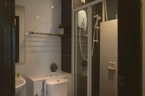 a bathroom with a shower and a toilet and a sink at The Majestic Ipoh by The Osborne in Ipoh