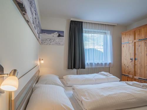 a bedroom with two beds and a window at Hohe Tauern in Mittersill