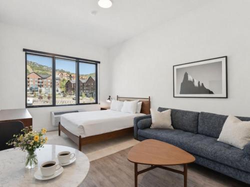 a living room with a couch and a bed at Pioche Village Park City in Park City
