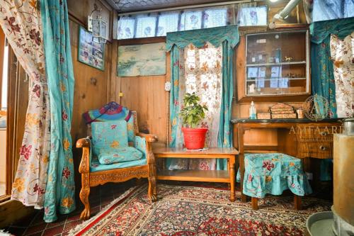 a room with a chair and a table and a window at Dolphin houseboat in Srinagar