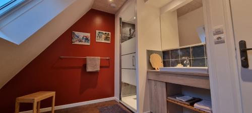 a bathroom with a sink and a mirror at Au Pré du Chêne in Le Faouët