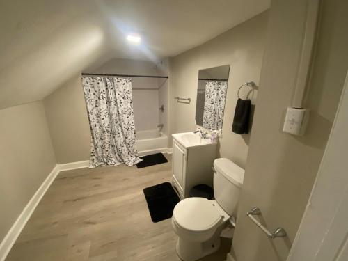 a small bathroom with a toilet and a window at The Heart house in Indianapolis
