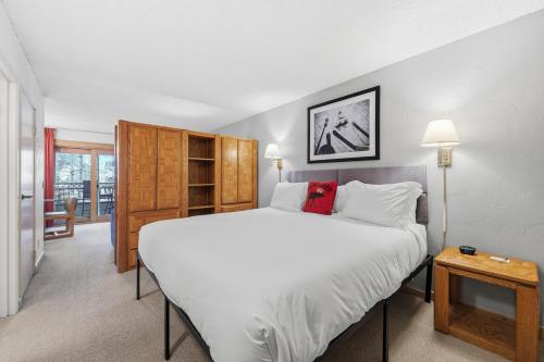 a bedroom with a large white bed and a table at Lift House Lodge, Vail Lionshead Studio Condo, Walk to Gondola in Vail