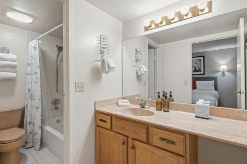 a bathroom with a sink and a toilet and a mirror at Lift House Lodge, Vail Lionshead Studio Condo, Walk to Gondola in Vail