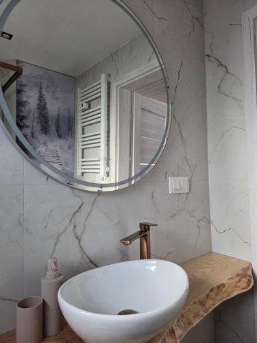 a bathroom with a white sink and a mirror at Witam Karpacz 2 in Karpacz