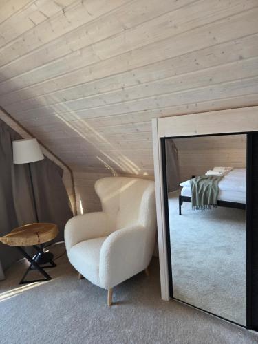 a bedroom with a mirror and a chair and a bed at Witam Karpacz 2 in Karpacz