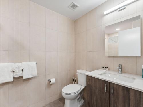 a white bathroom with a toilet and a sink at Pioche Village Park City in Park City