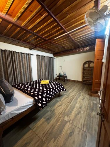 a bedroom with a bed and a wooden floor at Peaceful Mountain Cottage in Bhīm Tāl