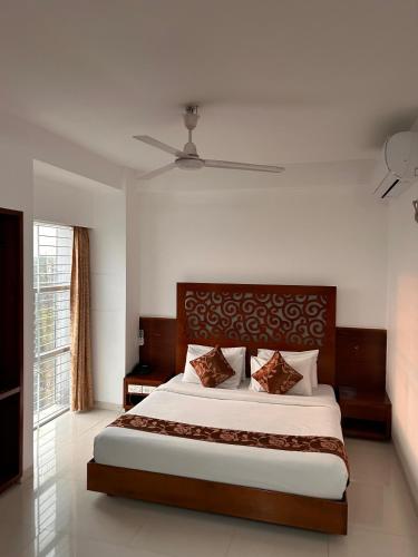 a bedroom with a large bed in a room at Sylhet La Vista in Sylhet
