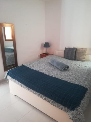 a bedroom with a bed with a blue pillow on it at Apartamentos Punta Mujeres alto derecha in Punta Mujeres