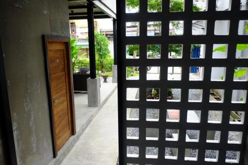 a door that is open to a building at Nokhook House in Trang