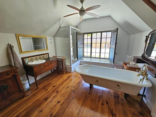 a large bathroom with a tub and a sink at The Gables in Hout Bay