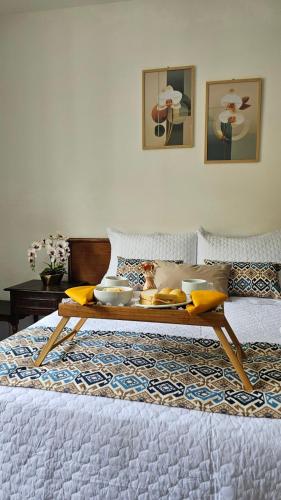 a room with a table on a bed at Pousada Villa Real in Sabará