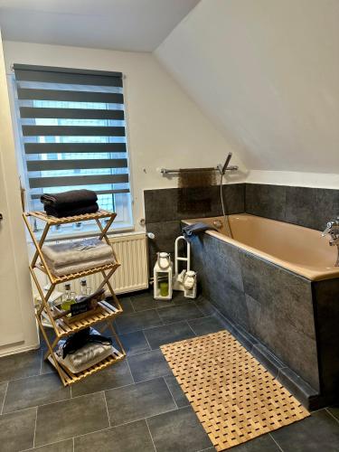 a bathroom with a large tub and a sink at Altstadt-Hotel Gosequell in Goslar