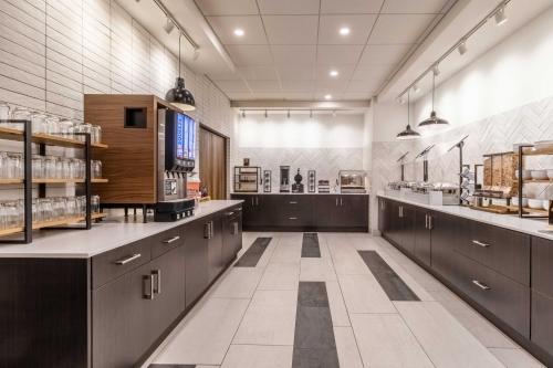 a large kitchen with dark brown cabinets and appliances at Staybridge Suites Halifax - Dartmouth by IHG in Halifax