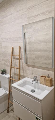 a bathroom with a sink and a mirror at Casa do Arco in Aljubarrota